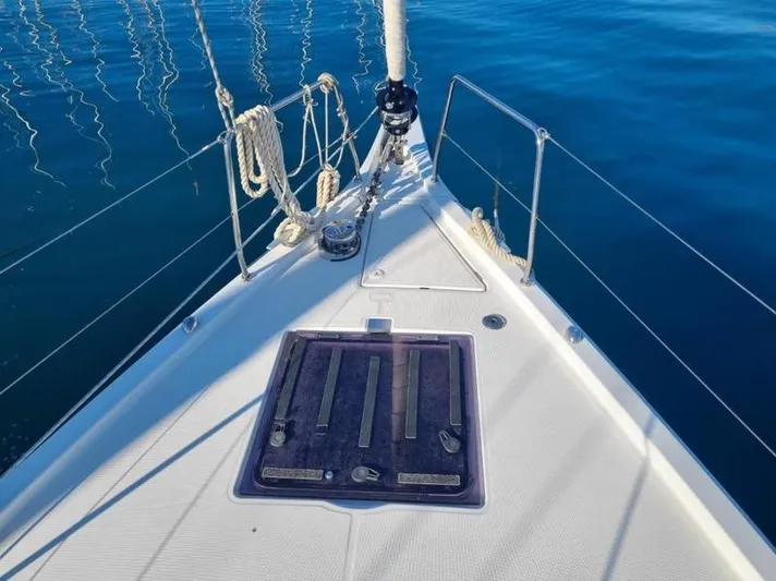 Miss Alice Yacht Photos Pics Bow of 2018 Beneteau 51.1 sailboat on calm blue water.