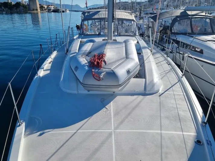 Miss Alice Yacht Photos Pics 2018 Beneteau 51.1 yacht deck with inflatable boat, docked in a marina.