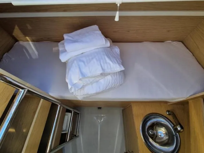 Miss Alice Yacht Photos Pics 2018 Beneteau 51.1 yacht cabin with bed, sink, and wooden interior.