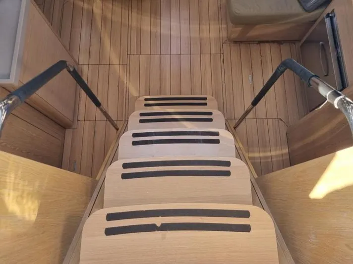 Miss Alice Yacht Photos Pics Staircase inside 2018 Beneteau 51.1 yacht with wooden steps and handrails.