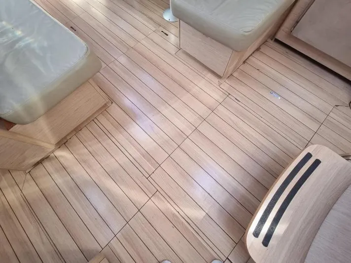 Miss Alice Yacht Photos Pics Interior view of 2018 Beneteau 51.1 yacht with wooden flooring and cushioned seating.