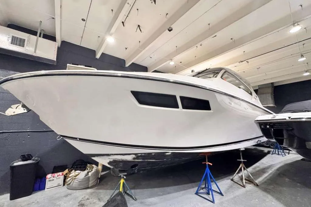 2018 Pursuit DC 365 Dual Console boat in indoor storage on stands.
