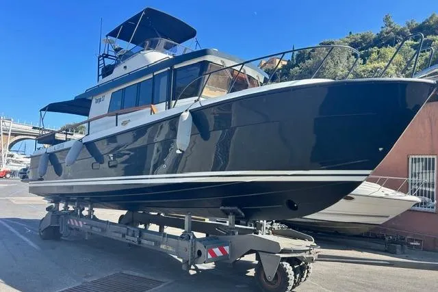  Yacht Photos Pics 2022 Targa 37 boat on trailer, dockside, under clear blue sky.