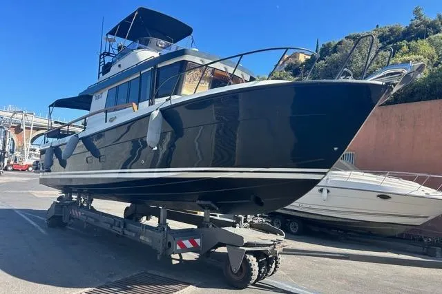  Yacht Photos Pics 2022 Targa 37 boat on trailer, dockside, under clear blue sky.
