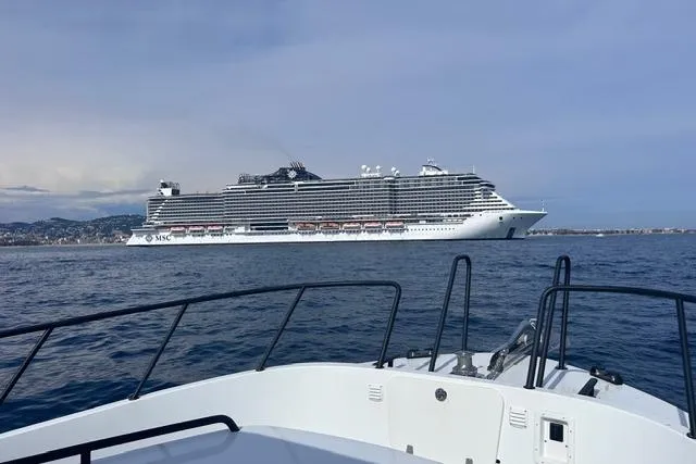  Yacht Photos Pics Targa 37 boat in foreground with large cruise ship in the background, 2022 model.