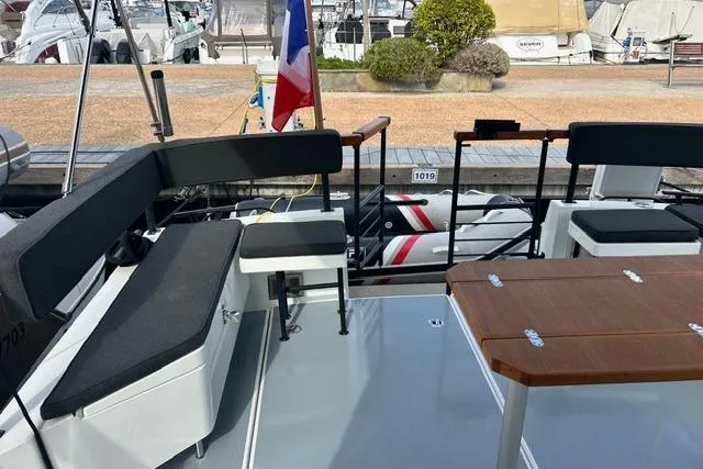  Yacht Photos Pics 2022 Targa 37 boat deck with seating and table, docked at marina.