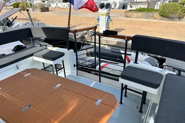  Yacht Photos Pics 2022 Targa 37 boat interior with seating and table, docked at marina.