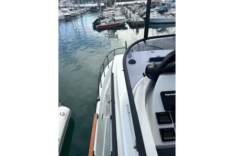  Yacht Photos Pics 2022 Targa 37 boat docked in a marina, surrounded by other vessels.