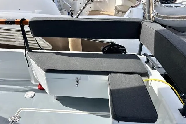  Yacht Photos Pics 2022 Targa 37 boat seating area with cushioned benches and storage compartment.