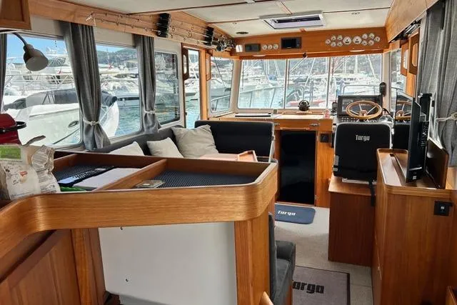 Yacht Photos Pics Luxurious 2022 Targa 37 yacht interior with wooden finishes and marina view.