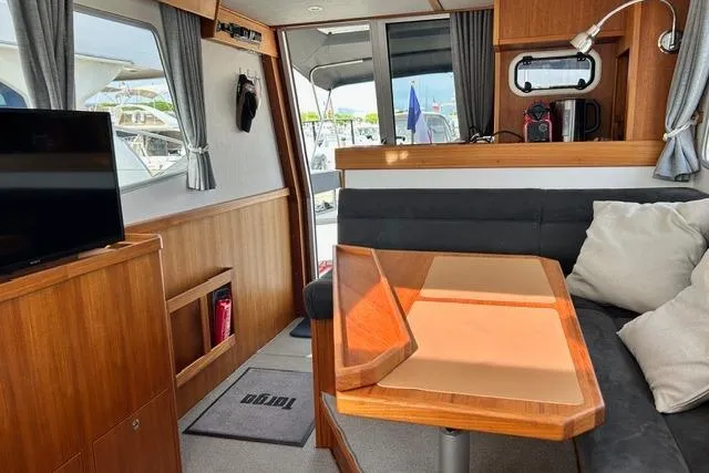  Yacht Photos Pics Interior of 2022 Targa 37 boat with wooden furnishings and modern seating area.