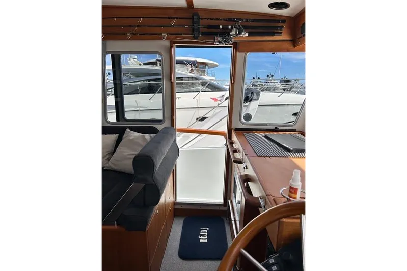 Yacht Photos Pics Interior view of 2022 Targa 37 boat with docked yachts outside.