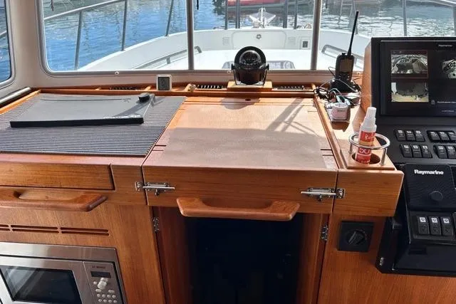  Yacht Photos Pics Interior of 2022 Targa 37 boat with navigation equipment and wooden cabinetry.