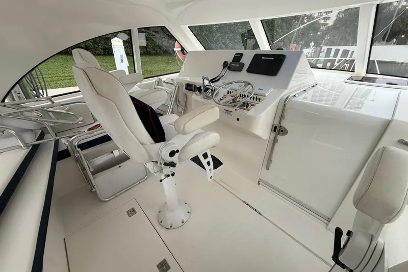  Yacht Photos Pics 2012 Cabo 40 Hardtop Express helm with white seating and navigation controls.