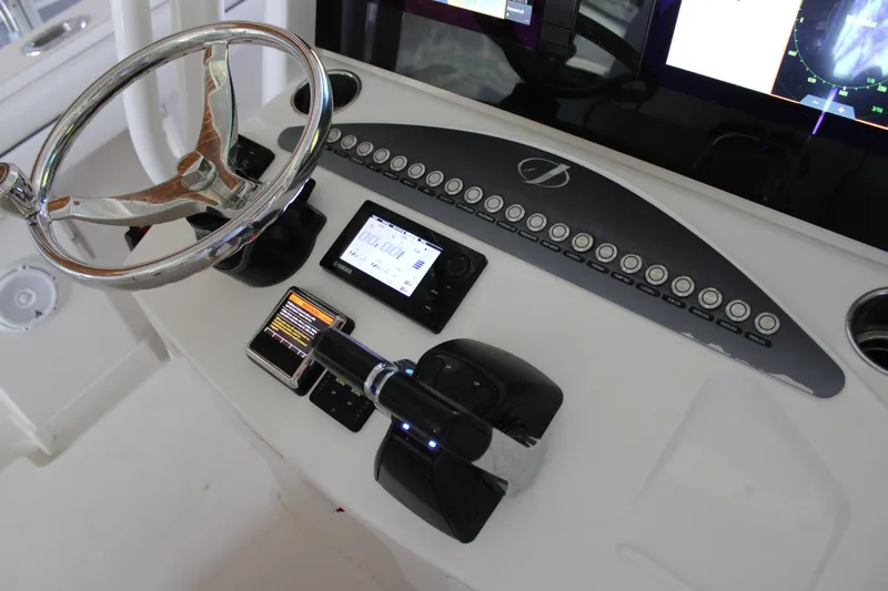 Yacht Photos Pics Control panel of a 2018 Jupiter 30 HFS boat with steering wheel and electronic displays.