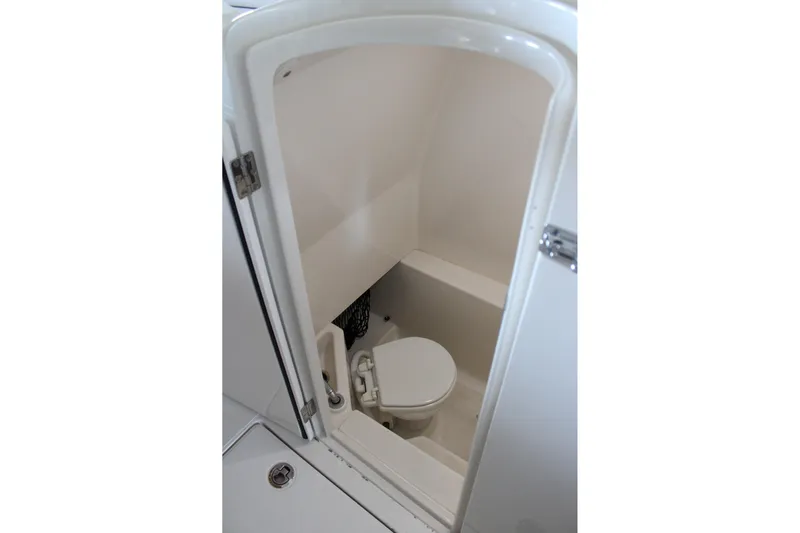  Yacht Photos Pics Compact marine toilet inside 2018 Jupiter 30 HFS boat cabin.