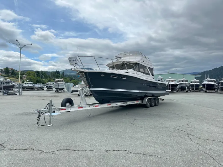  Yacht Photos Pics 2025 Cutwater C-32 CB boat on trailer, for sale in marina parking lot.