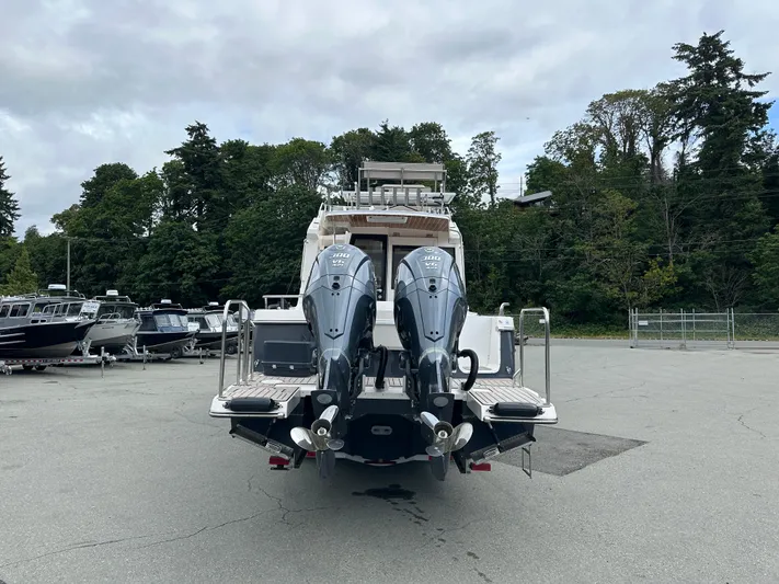  Yacht Photos Pics 2025 Cutwater C-32 CB boat with dual outboard engines, parked outdoors.