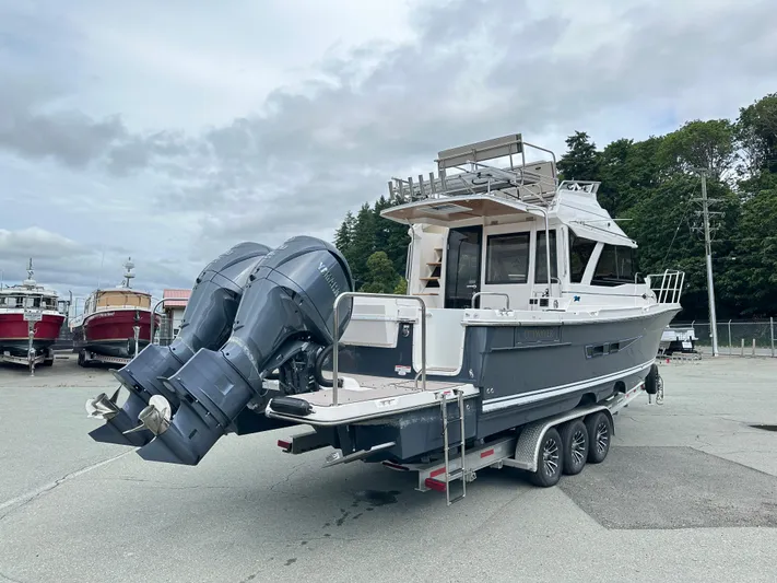  Yacht Photos Pics 2025 Cutwater C-32 CB boat on trailer with dual outboard engines, parked outdoors.