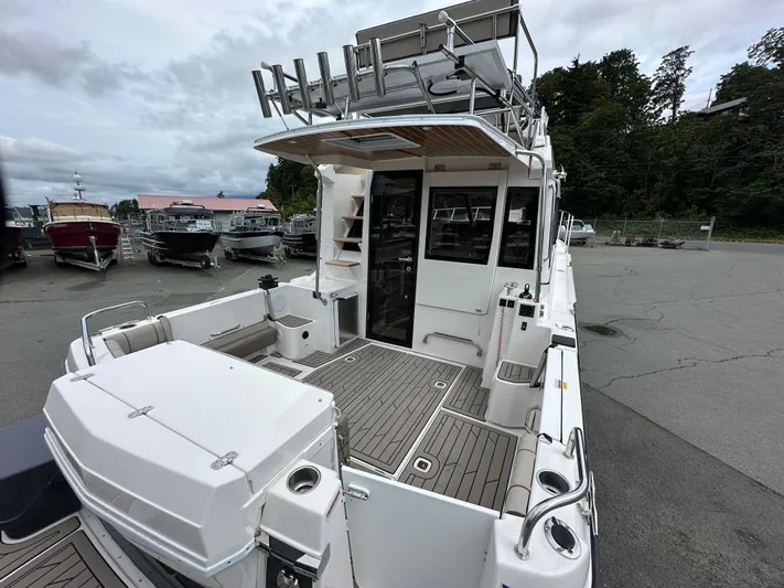  Yacht Photos Pics 2025 Cutwater C-32 CB boat with spacious deck and modern design in a marina setting.