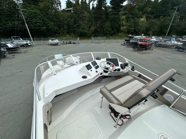  Yacht Photos Pics 2025 Cutwater C-32 CB boat helm with seating, docked in a marina.