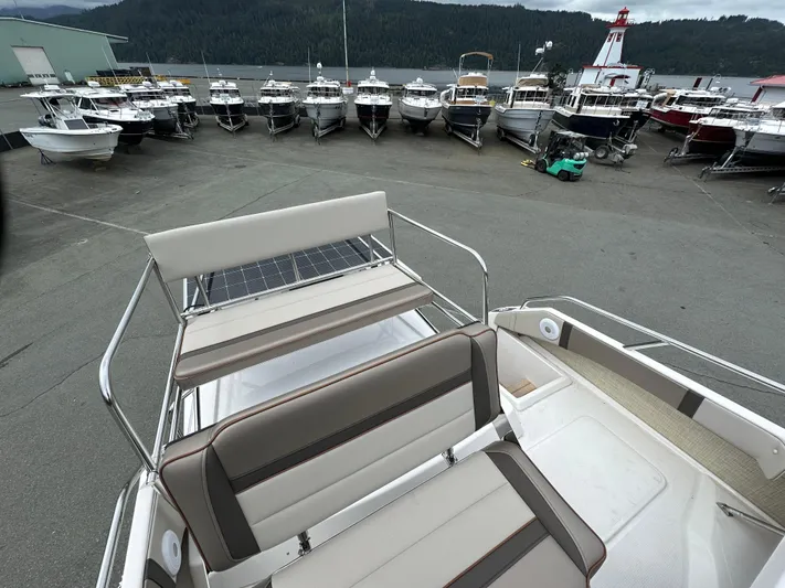  Yacht Photos Pics 2025 Cutwater C-32 CB boat on dock, surrounded by other boats and scenic background.