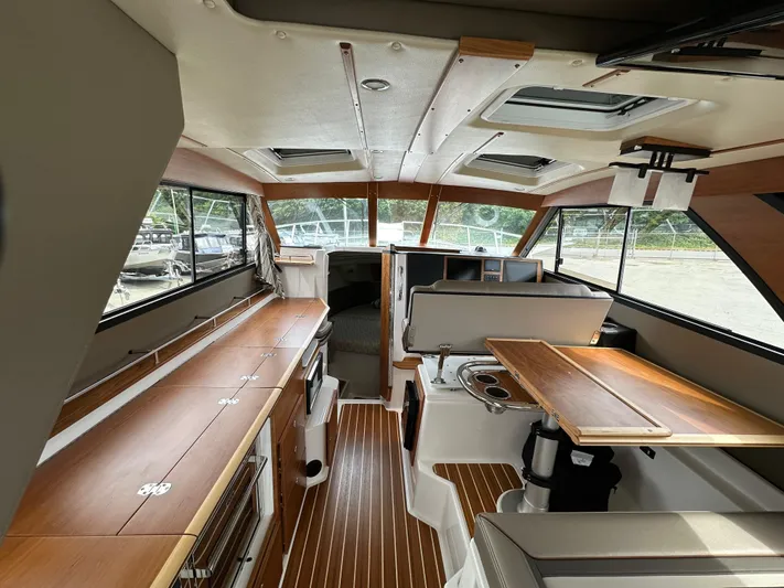  Yacht Photos Pics Interior of 2025 Cutwater C-32 CB boat, featuring wood finishes and modern design.