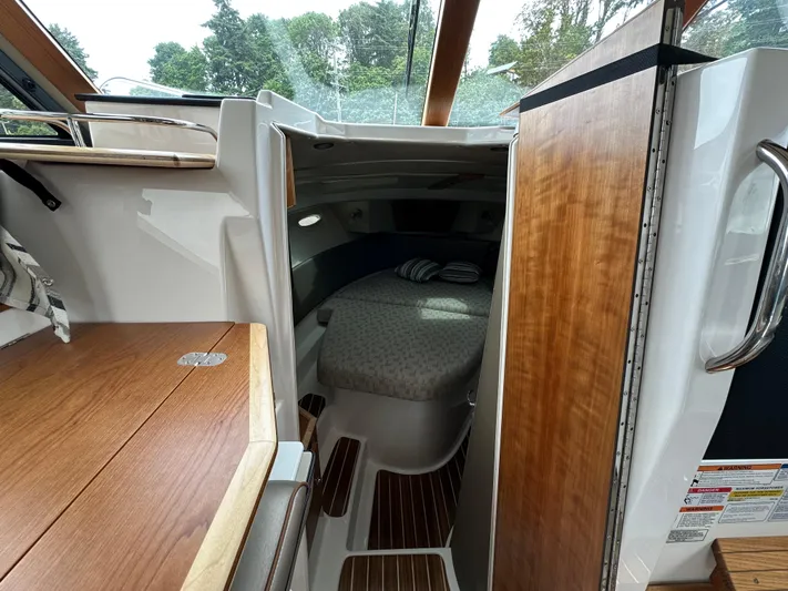  Yacht Photos Pics 2025 Cutwater C-32 CB cabin interior with wooden finishes and cozy sleeping area.