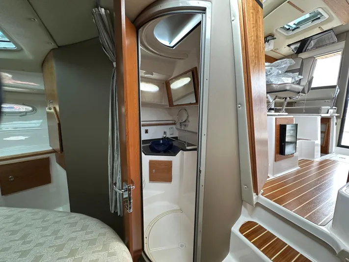  Yacht Photos Pics 2025 Cutwater C-32 CB interior with modern design, featuring a compact bathroom and seating area.
