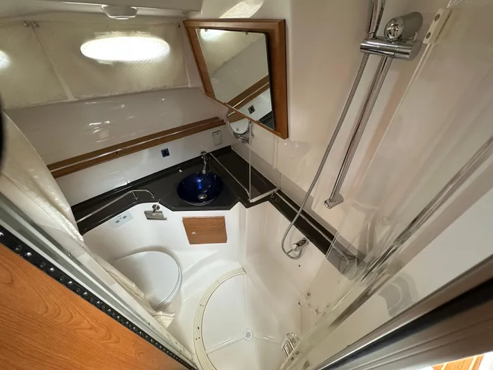  Yacht Photos Pics 2025 Cutwater C-32 CB bathroom with shower, sink, and mirror.