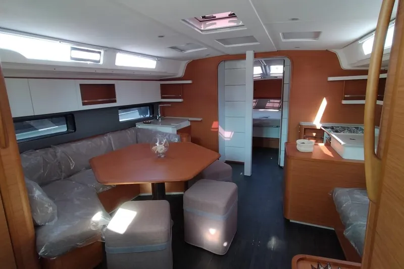  Yacht Photos Pics 2024 Dufour 44 yacht interior with modern dining area and kitchen.