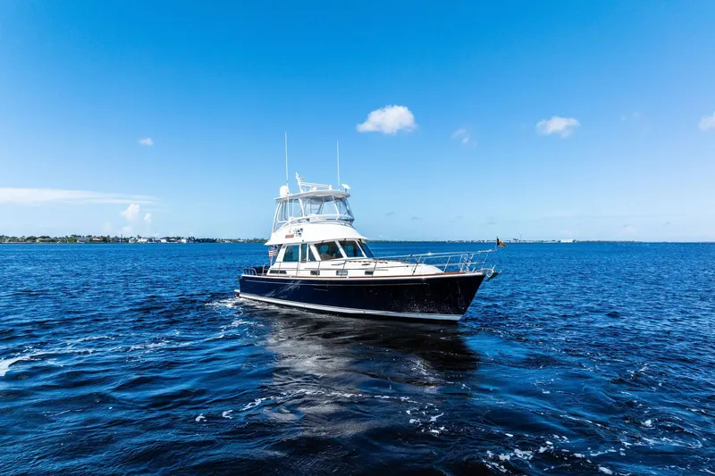 Highlander Yacht Photos Pics 2019 Sabre Flybridge yacht cruising on open blue water under clear skies.