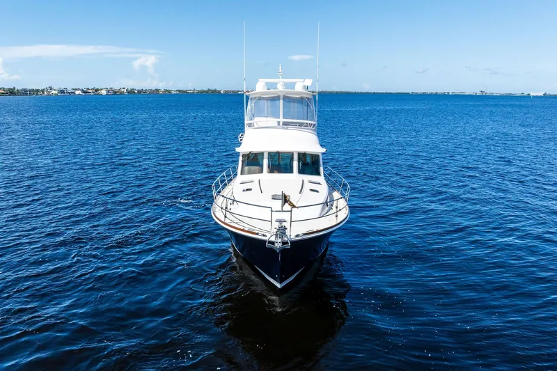 Highlander Yacht Photos Pics 2019 Sabre Flybridge yacht cruising on open blue waters under clear skies.