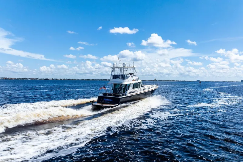 Highlander Yacht Photos Pics 2019 Sabre Flybridge cruising on open water under a clear blue sky.