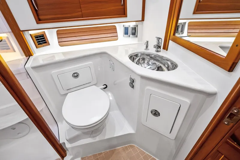 Highlander Yacht Photos Pics 2019 Sabre Flybridge yacht bathroom with modern fixtures and wooden accents.