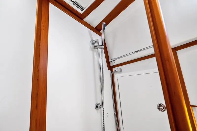 Highlander Yacht Photos Pics Shower area in 2019 Sabre Flybridge yacht with wooden trim and chrome fixtures.