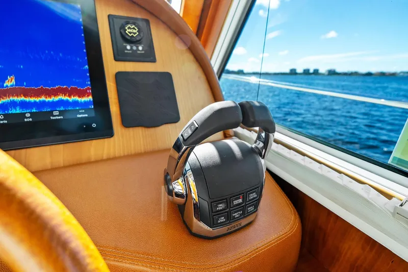 Highlander Yacht Photos Pics 2019 Sabre Flybridge helm with control panel and scenic ocean view.