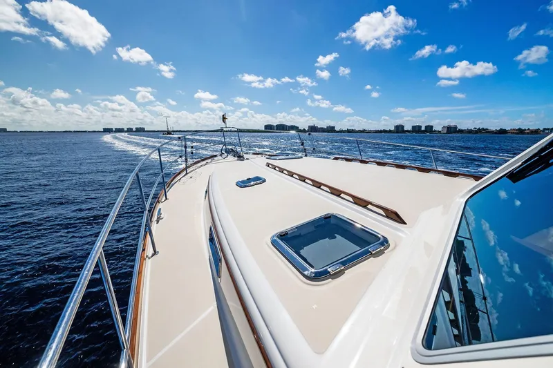 Highlander Yacht Photos Pics 2019 Sabre Flybridge yacht cruising on open water under a clear blue sky.