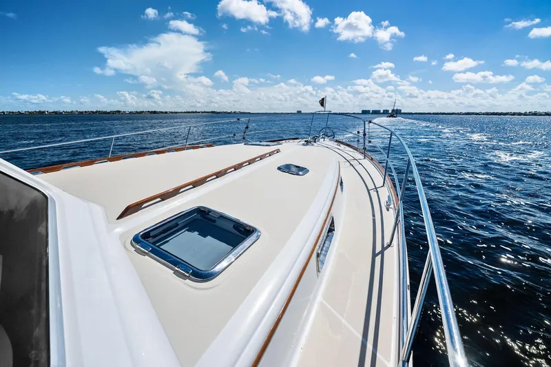 Highlander Yacht Photos Pics 2019 Sabre Flybridge yacht cruising on open water under a clear blue sky.
