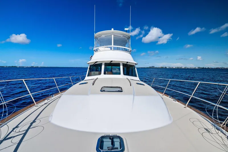 Highlander Yacht Photos Pics 2019 Sabre Flybridge yacht on open water under clear blue sky.