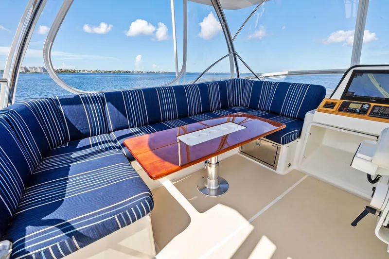Highlander Yacht Photos Pics Luxurious 2019 Sabre Flybridge yacht interior with striped seating and ocean view.