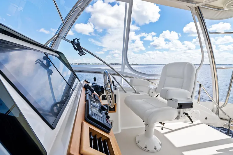 Highlander Yacht Photos Pics 2019 Sabre Flybridge helm with white captain's chair and ocean view.