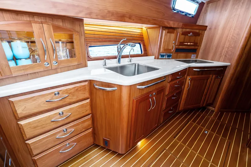 Highlander Yacht Photos Pics Luxurious wooden kitchen interior of 2019 Sabre Flybridge yacht with modern amenities.