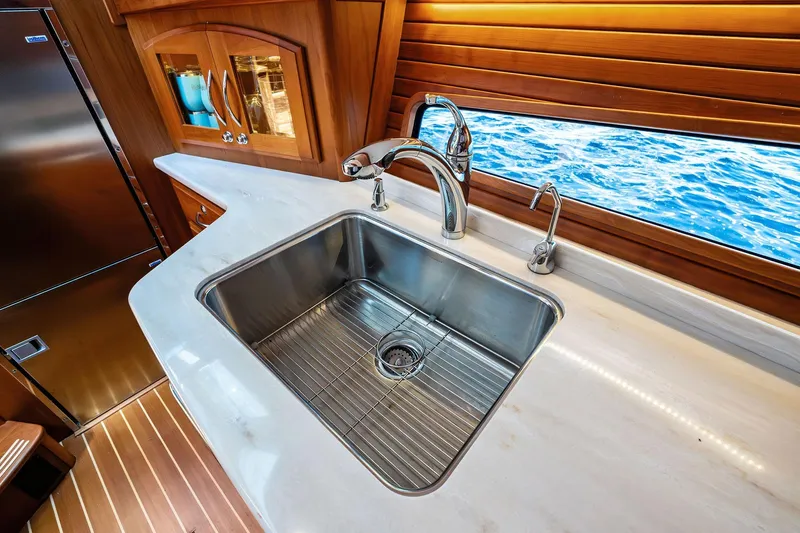 Highlander Yacht Photos Pics Luxurious 2019 Sabre Flybridge yacht kitchen with stainless steel sink and ocean view.