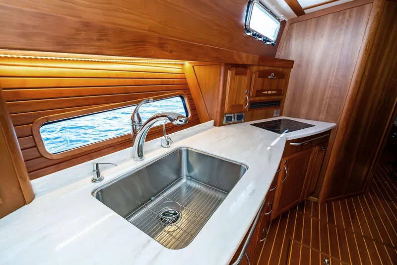 Highlander Yacht Photos Pics Luxurious 2019 Sabre Flybridge yacht kitchen with wooden cabinetry and ocean view.