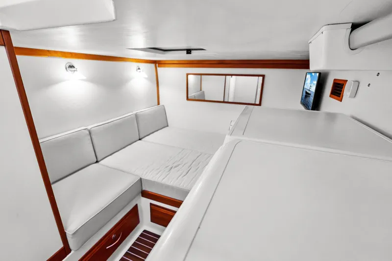 Highlander Yacht Photos Pics 2019 Sabre Flybridge interior with white seating, wooden accents, and wall-mounted TV.