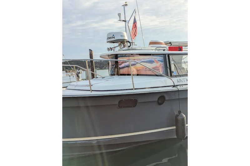 Knot Working Yacht Photos Pics 2020 Ranger Tugs R-27 boat docked with American flag and marine equipment.