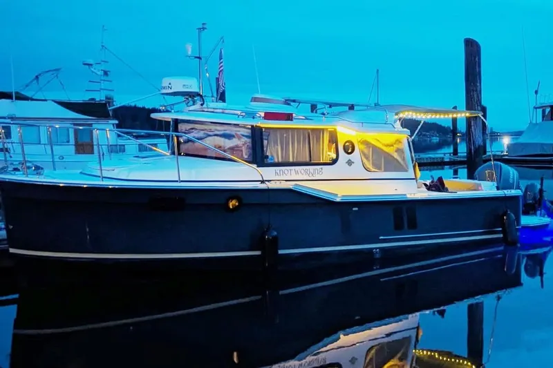 Knot Working Yacht Photos Pics 2020 Ranger Tugs R-27 boat docked at marina during twilight.