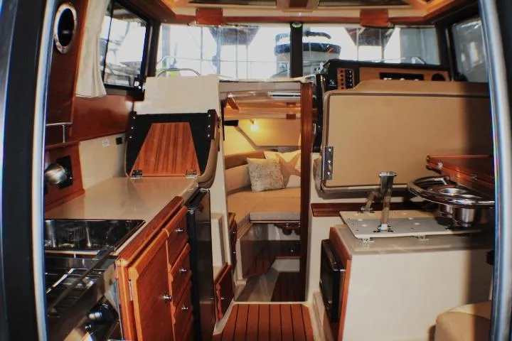 Knot Working Yacht Photos Pics Interior of 2020 Ranger Tugs R-27 boat, featuring cozy cabin and modern amenities.