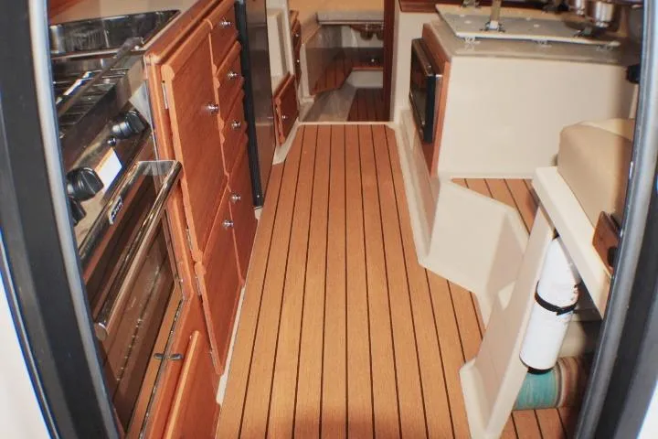 Knot Working Yacht Photos Pics Interior of 2020 Ranger Tugs R-27 boat with wood flooring and kitchen amenities.